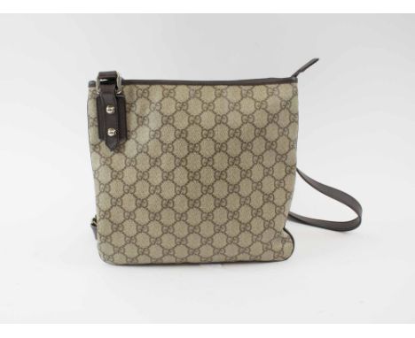 GUCCI CROSSBODY VINTAGE FLAT MESSENGER BAG, with iconic GG monogram canvas, leather trims and adjustable strap, top zip closu
