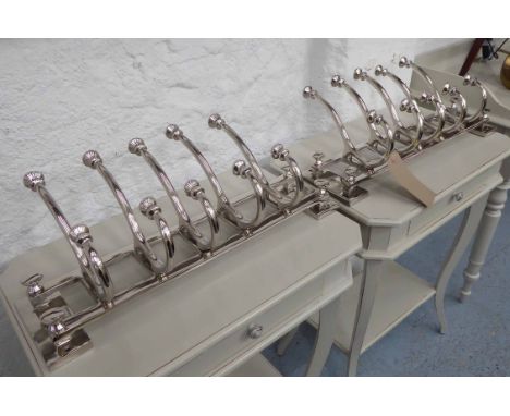 WALL COAT HANGERS, a pair, chrome metal, contemporary designs, with wall fixing inserts, 27cm H  x 59cm L. (2)