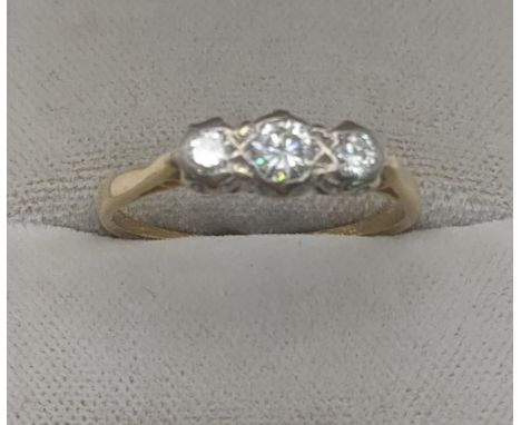 A three stone diamond trilogy ring set in white metal with yellow metal shank, yellow metal tested as 18ct gold, size R, 2.2g
