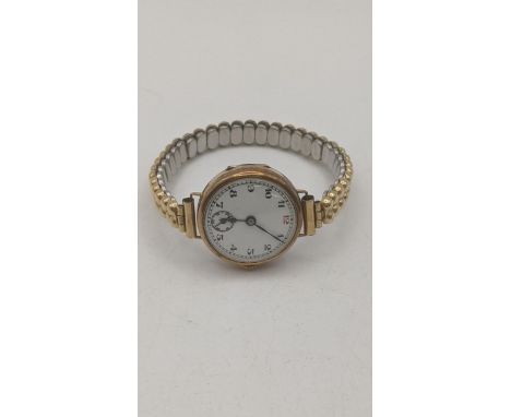An early 20th century 9ct yellow gold cased ladies manual wind wrist watch on a gold plated expanding bracelet, total weight 