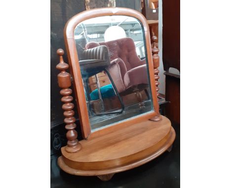 A Victorian toilet mirror with bobbin turned supports.Condition- there is some movement to the bobbin supports and some sligh
