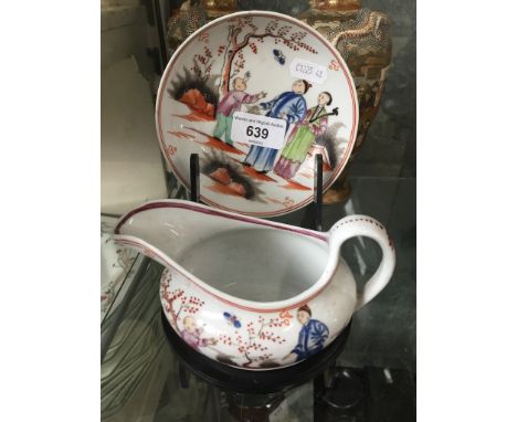 A New Hall gravy boat and saucer, circa 1850.Condition:- General wear through age and use, hairline crack to saucer, no other