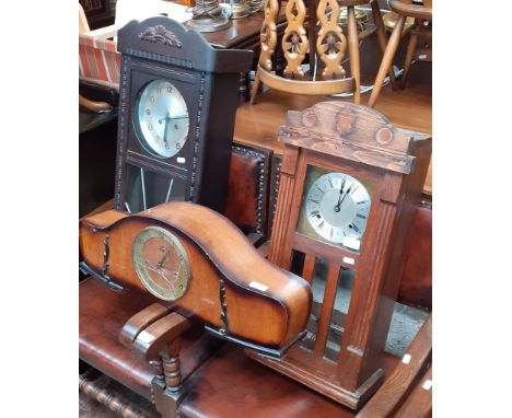 Two early 20th century oak cased wall clocks and an early 20th century mantle clock. 
