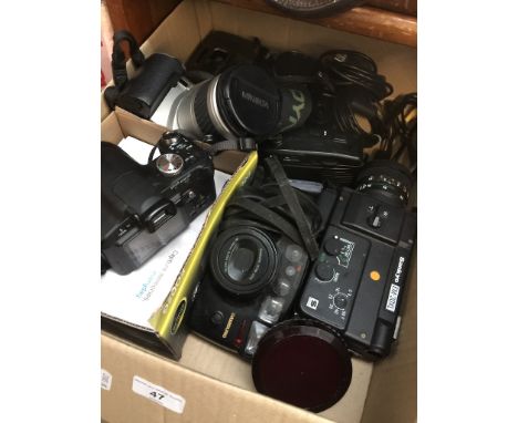 A box of cameras and accessories to include Minolta 404si, Panasonic DMC-FZ18, Sankyo EM-30XL cine camera, etc. 