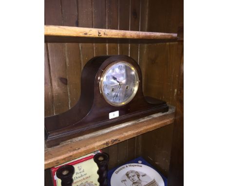 A domed top mantle clock. 