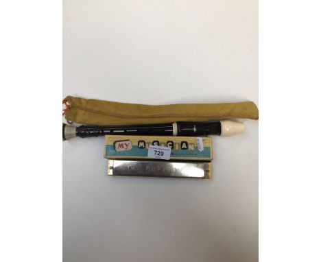 A recorder in cloth bag and a boxed vintage My Musician harmonica 