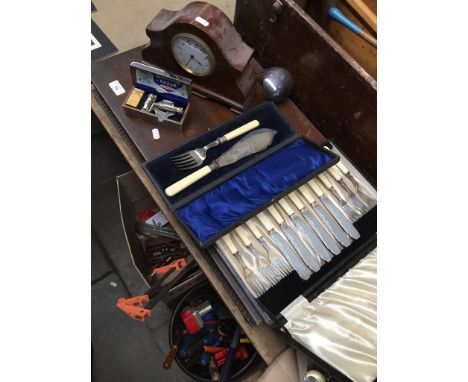 A canteen of cutlery, boxed set of fish server, plated ladle, a set of 6 knives and forks, a vintage razor and a mantel clock