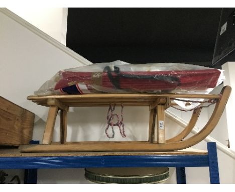 A VINTAGE WOODEN SLEIGH AND PLASTIC KIDS SKI