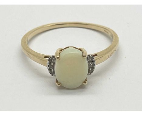 Gemporia; A 9ct Gold Opal Dress Ring, single oval cut to centre, between stone set crescent shoulders and slim tapered band s