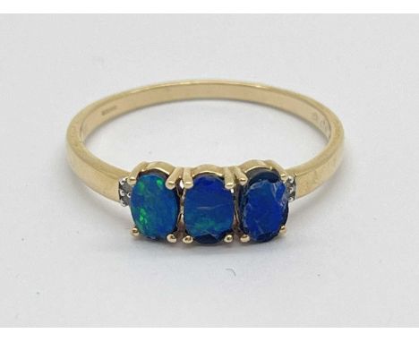 Gemporia; A 9ct Gold Opal Doublet (?) Three Stone Ring, four claw set throughout between stone set shoulders and tapering ban