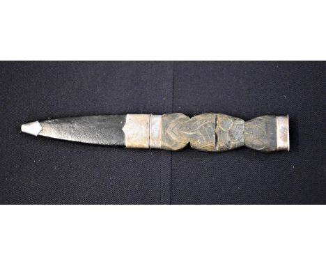 Scottish Highland Dirk, a Celtic design on the handle with white-metal hilt and pommel and attachments on the scabbard. 20.5c