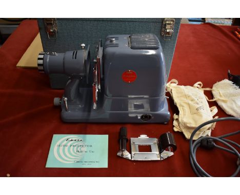 Ebata Model 500 Slide Projector, F/3.0 Projection lens and takes 6cmx6cm slides and 35mm strip film Complete with case. Made 