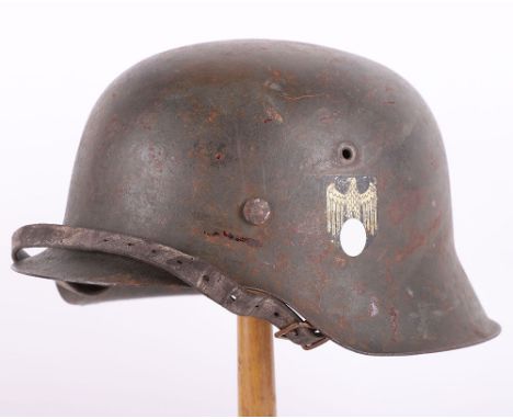 WW2 German Army Single Decal M-42 Steel Combat Helmet, retaining much of the original field grey paint finish to the shell. C
