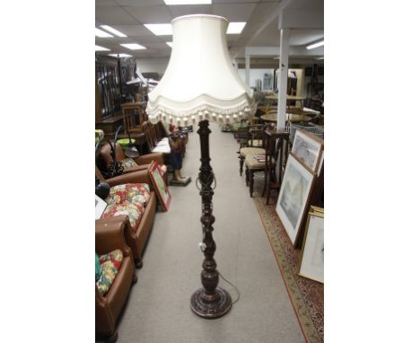 A turned and fluted standard lamp with shade