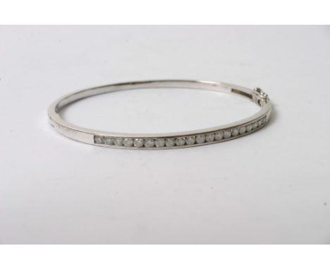 A ladies 9ct white gold bangle channel set with approximately 1ct of brilliant cut diamonds