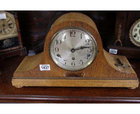 An oak mantel clock with Arabic numerals