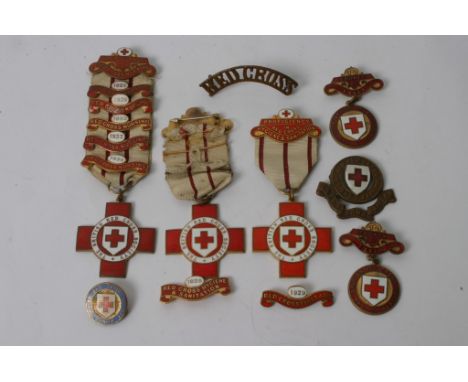 A collection of 1930s enamel Red Cross medals and badges