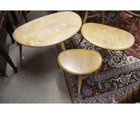 A nest of three light wood Ercol pebble tables