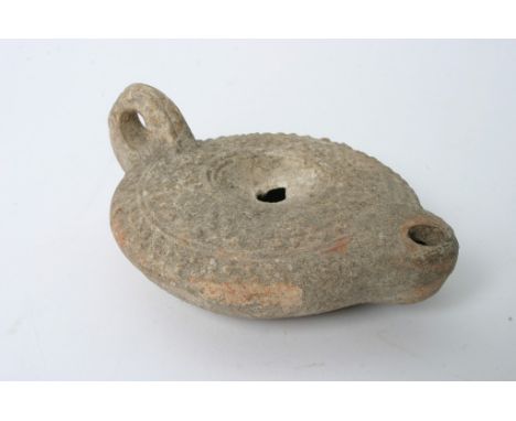 A small Roman style terracotta oil lamp