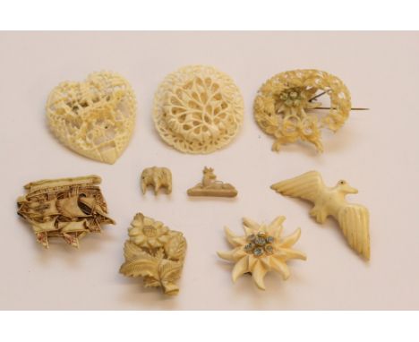 A collection of assorted vintage brooches including carved bone and ivory