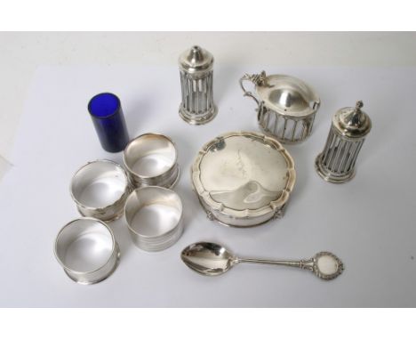 A silver cruet set with four napkin rings and a trinket box