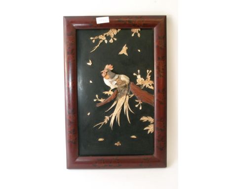 An oriental lacquer panel with applied mother of pearl and bone carvings in the form of a cockerel
