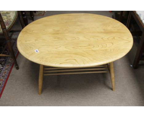 An Ercol light wood circular occasional table