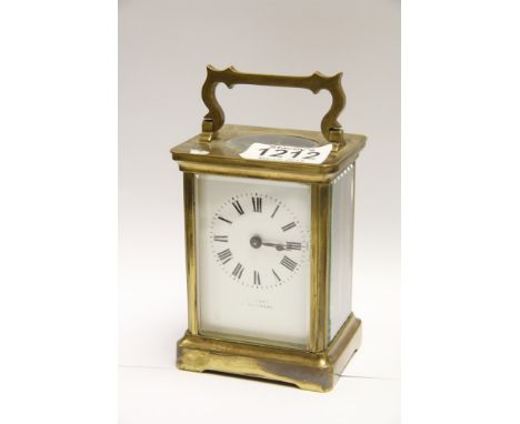 A brass cased carriage clock with a rectangular enamel dial 