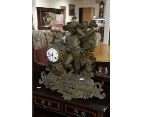 A French spelter mantle clock with boy holding grapes