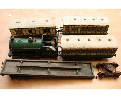 An old scratch built clock work steam engine 11/2 inch gauge with conforming wood carriages and track