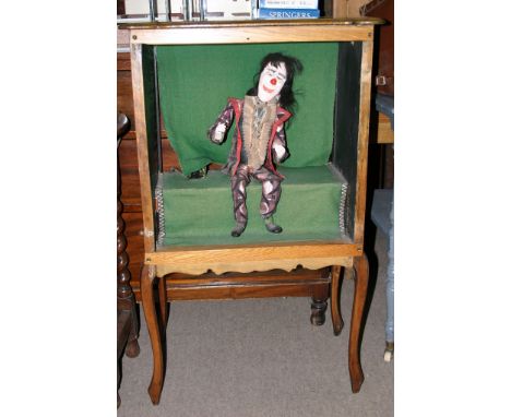 A cased Automaton in the form of a clown 