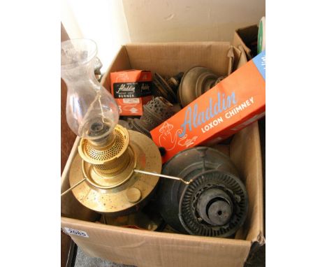A box containing old brass oil lamp parts including Aladdin