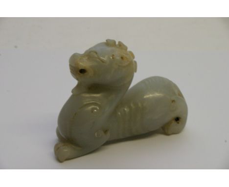 A Chinese white jade carving in the form of a mythical beast. Length: 9.5cm approximately