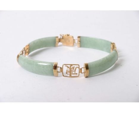 A gold mounted jade bracelet with Chinese symbols for the links