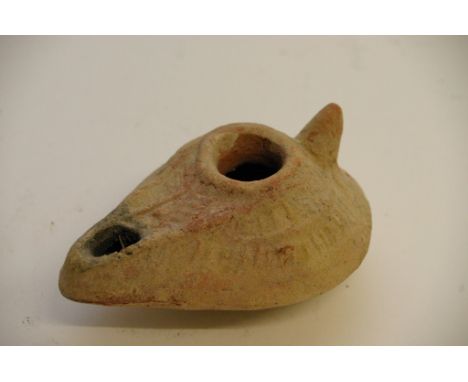 A small pottery Roman type oil lamp