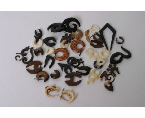 A collection of assorted wooden and bone tribal style earrings
