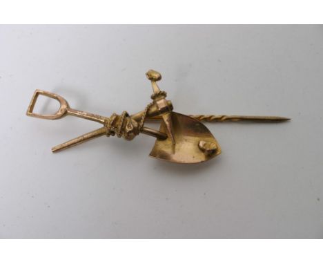 An unusual 9cg old stick pin in the form of gold diggers tools comprising a shovel and pick axe with gold nuggets