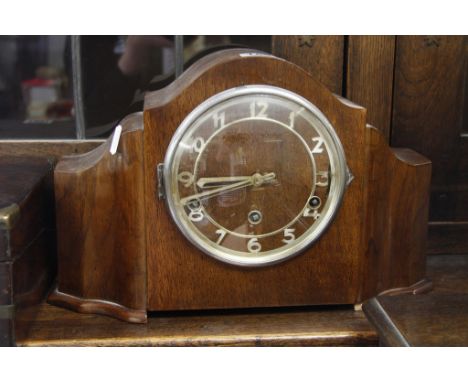 A walnut cased mantle clock with Arabic numerals