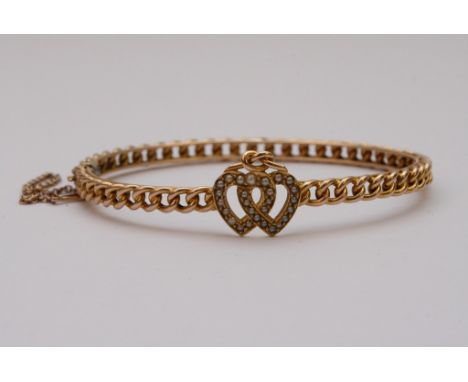 A 15ct yellow gold bangle with double heart seed pearl set motif, boxed
