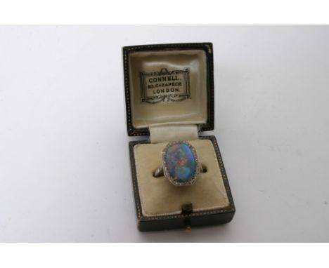 A platinum and diamond ring inset with a good size opal 