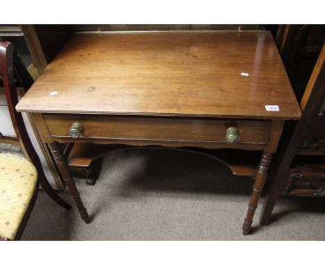 A Late George III Mahogany Dressing table,with an under shelf and turned legs