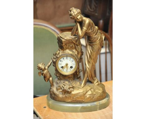 A Spelter Mantel clock; the enamel dial has Arabic numerals and is flanked by an Art Nouveau style maid on a green onyx base