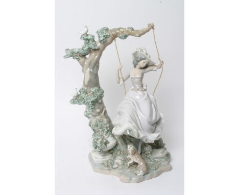 A large Lladro figure of a girl on swing, foot chipped