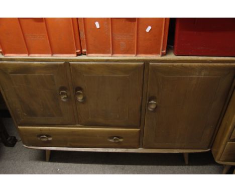 A collection of furniture comprising Ercol table, sideboard and a stick back chair 