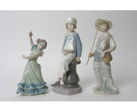 A collection of three porcelain figures by Lladro comprising a fisherman, a boy holding a model sailing boat and a young danc