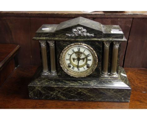 A Victorian green veined marble mantle clock with visible escapement and French movement