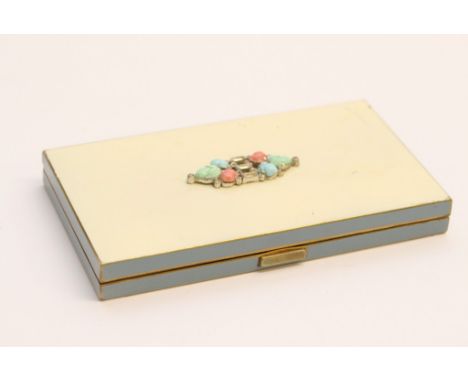 A vintage American powder compact by Volupte with paste set lid