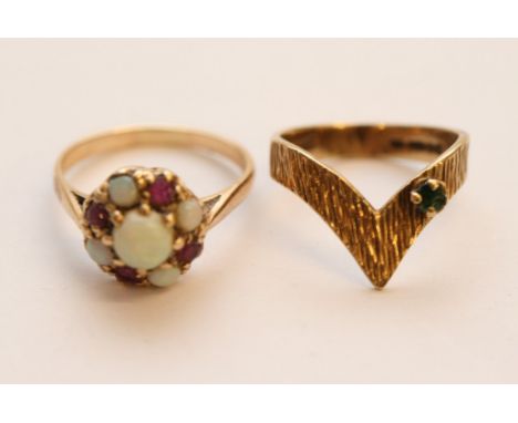 Two ladies 9ct yellow gold rings, one of wishbone shape and set with a single emerald together with a ruby and opal cluster r