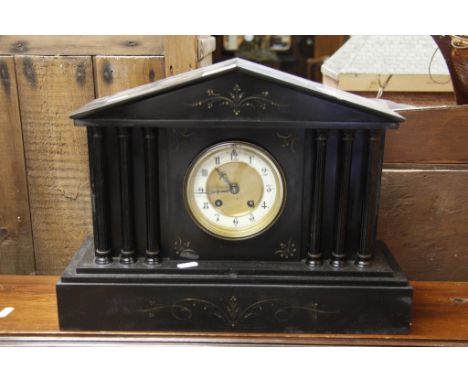 A large black slate mantle clock with Arabic numerals dial