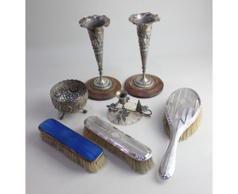 Two George V silver backed dressing table brushes Birmingham 1932, a pair of Indian embossed white metal vases on circular wo